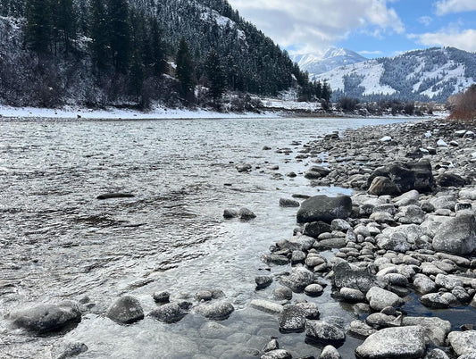 river in the winter near moutains